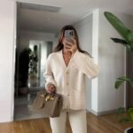 Cream cardigan with gold buttons and front pockets