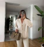 Cream cardigan with gold buttons and front pockets