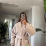 Ecru belted coat with a wide open collar