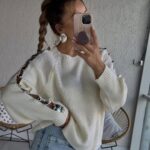 Cream knit sweater with lace-up metallic sleeve details