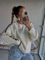 Cream knit sweater with lace-up metallic sleeve details