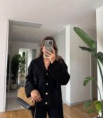 Black cardigan with gold buttons and front pockets