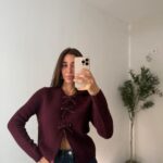 Burgundy knit cardigan with beaded bow closures