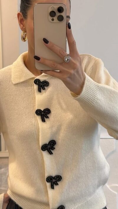 Cream knit cardigan with black bow buttons