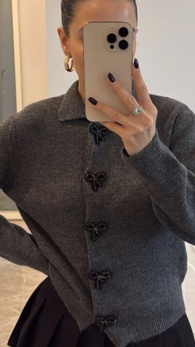 Grey knit cardigan with black bow buttons