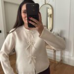 Off white knit cardigan with beaded bow buttons