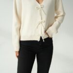 Off white top with beaded bow buttons